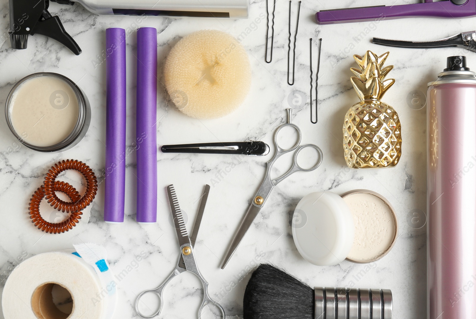 Photo of Flat lay composition with professional hairdresser tools on marble background