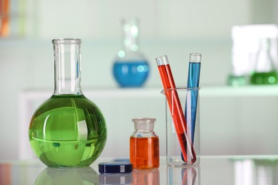 Laboratory analysis. Different glassware with liquids on white table indoors