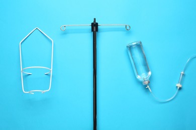Photo of IV infusion set on light blue background, flat lay
