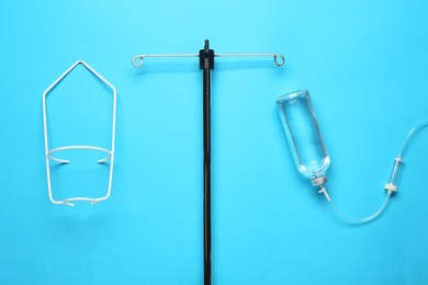 IV infusion set on light blue background, flat lay