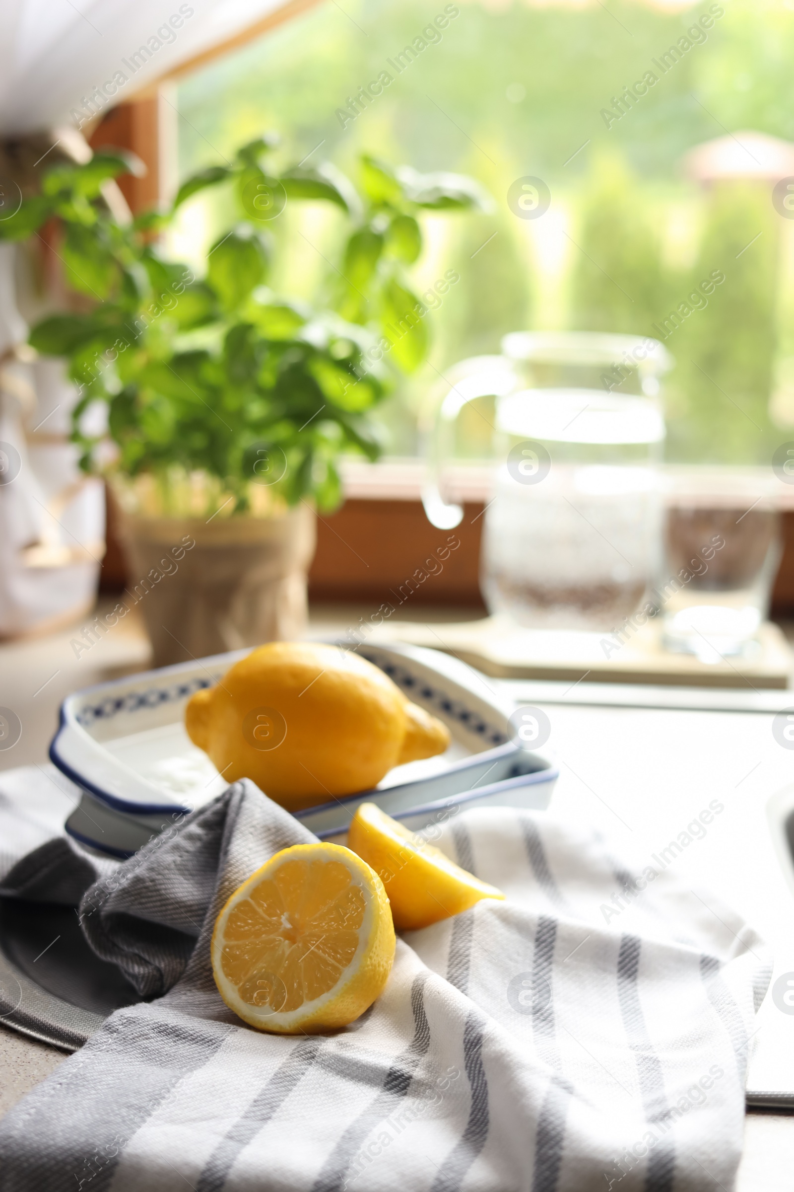 Photo of Fresh ripe lemons on countertop in kitchen, space for text