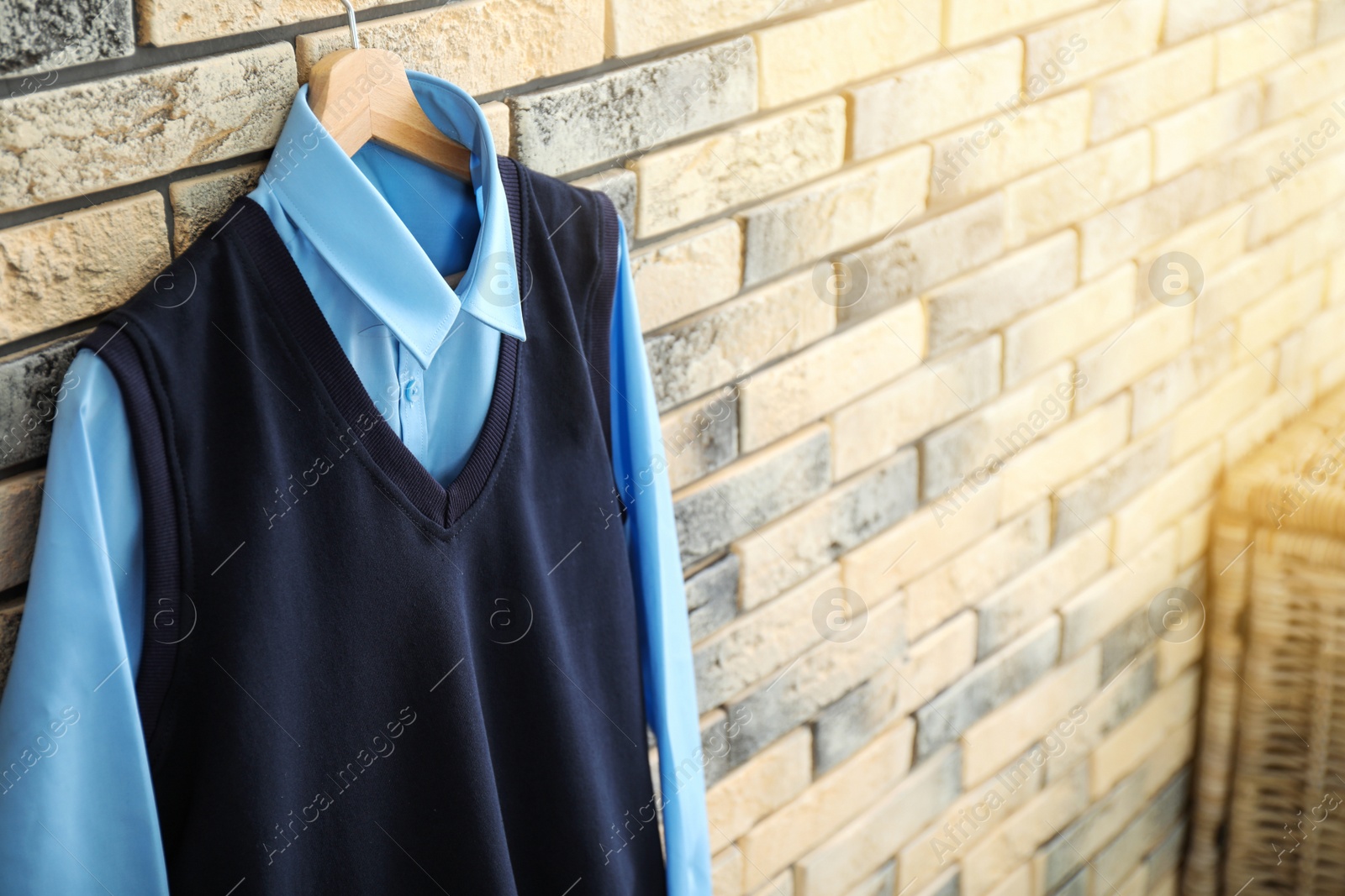 Photo of School uniform for boy hanging on brick wall