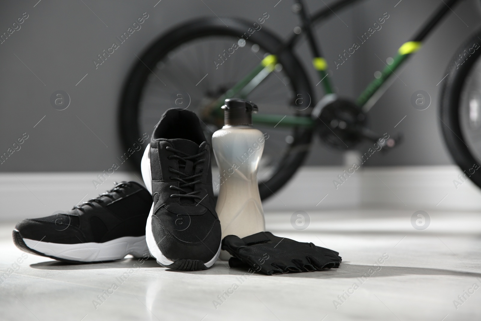 Photo of Bicycle gloves, shoes and bottle on floor 