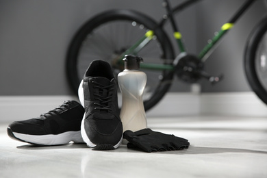 Photo of Bicycle gloves, shoes and bottle on floor 