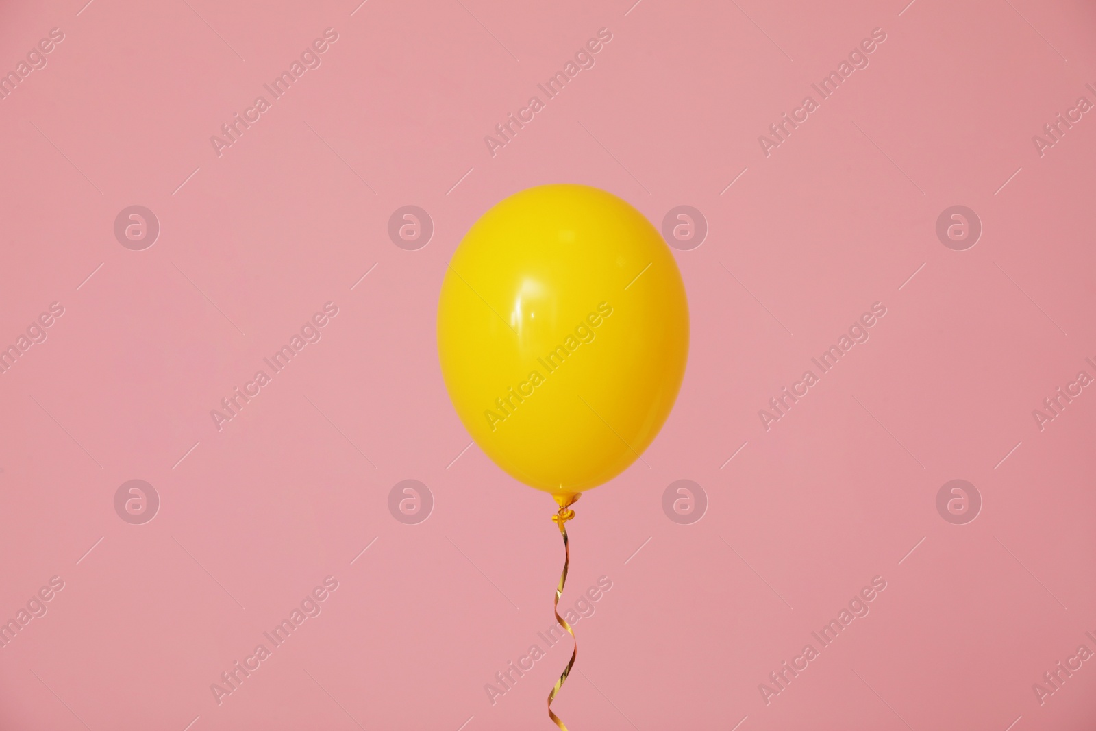 Photo of Bright balloon on color background. Celebration time