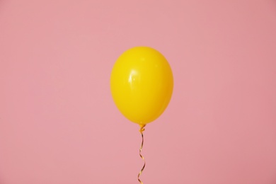 Photo of Bright balloon on color background. Celebration time