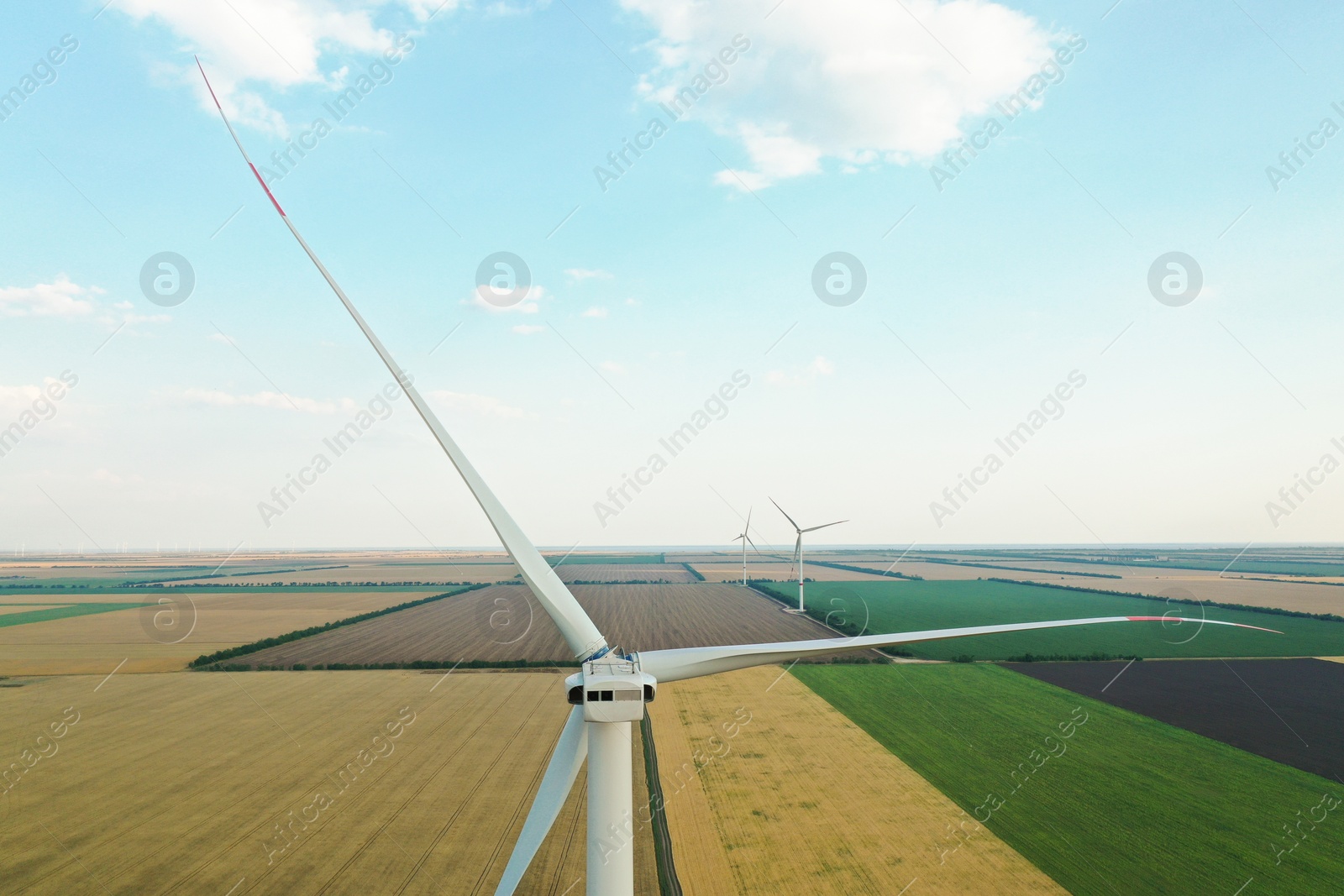 Photo of Modern windmill in wide field. Energy efficiency