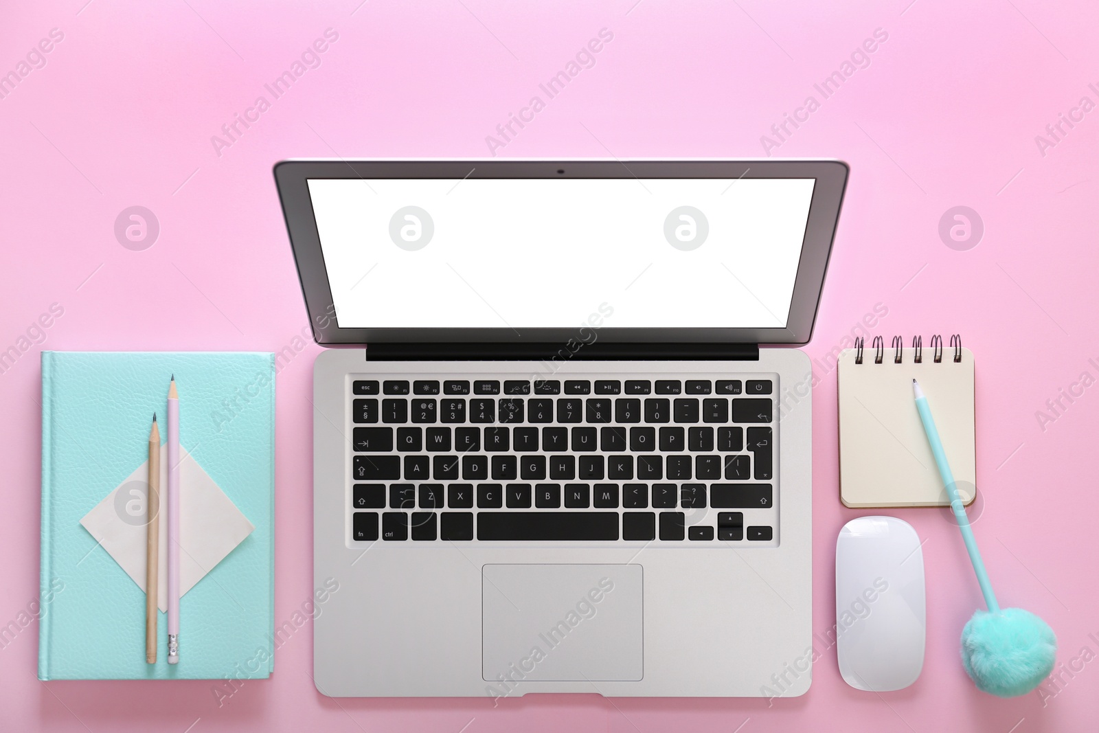 Photo of Modern laptop and office stationery on pink background, flat lay