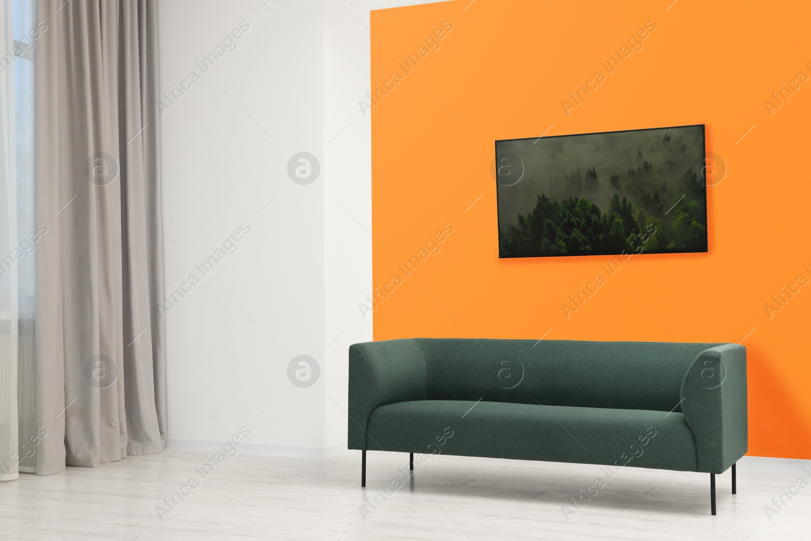 Photo of Beautiful interior with sofa near orange wall