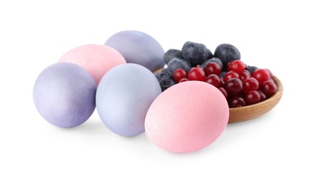 Naturally painted Easter eggs on white background. Blueberries and cranberries used for coloring