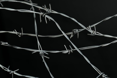 Photo of Shiny metal barbed wire on black background