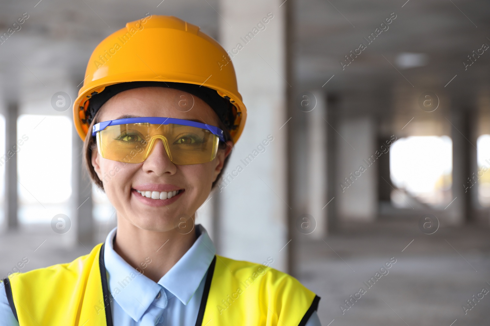 Photo of Professional engineer in safety equipment at construction site, space for text