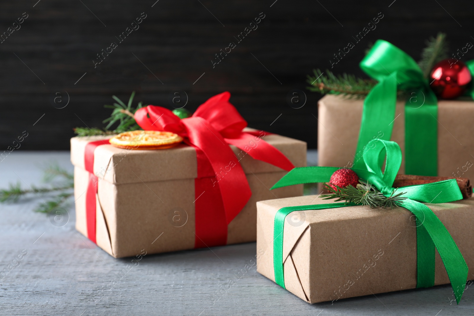 Photo of Different wrapped Christmas gifts on wooden table