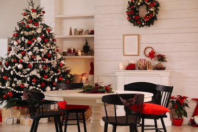 Cozy dining room interior with Christmas tree and festive decor