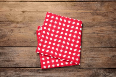 Checkered tablecloth on wooden table, top view