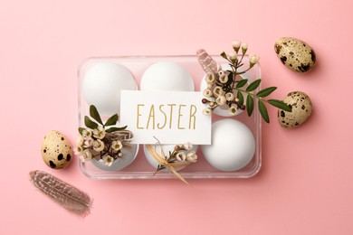 Photo of Flat lay composition with chicken eggs, natural decor and word Easter on pink background. Happy celebration