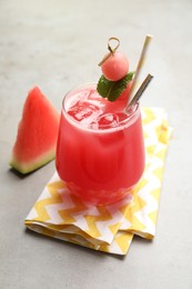 Delicious fresh watermelon drink on grey table