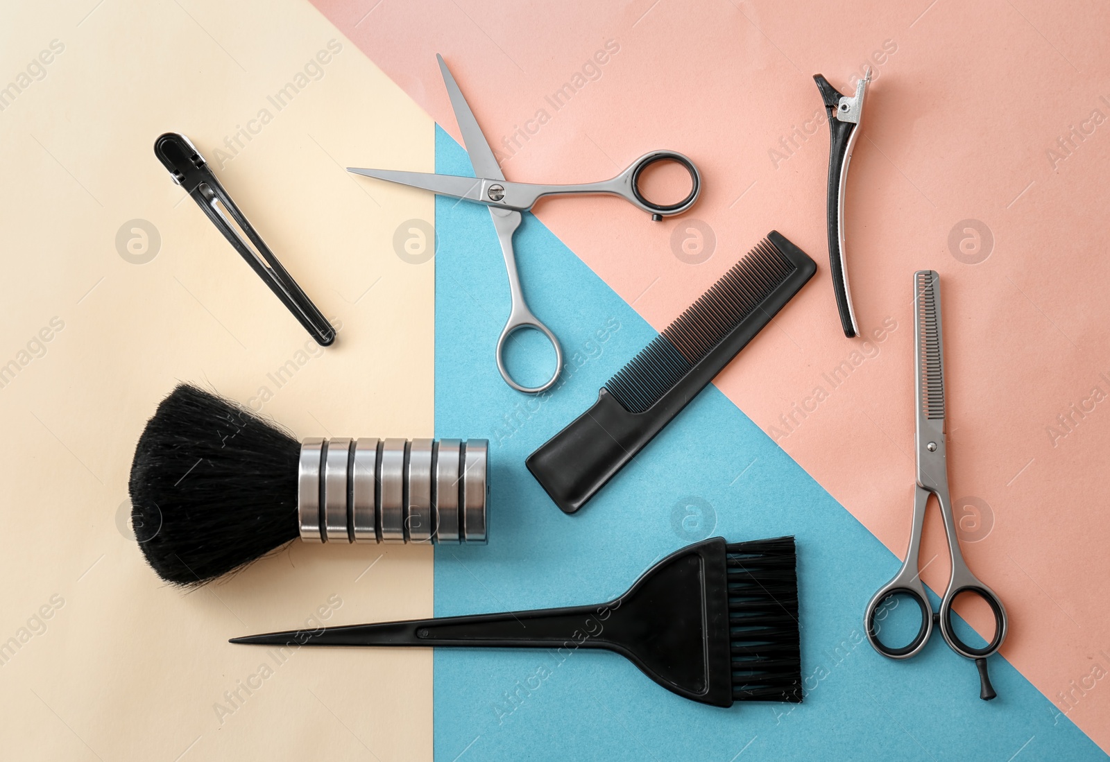 Photo of Flat lay composition with professional hairdresser tools on color background