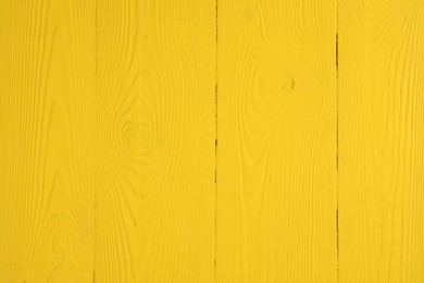 Photo of Texture of yellow wooden surface as background, closeup