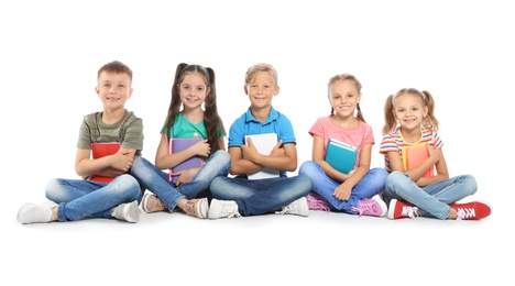 Photo of Group of little children with school supplies on white background