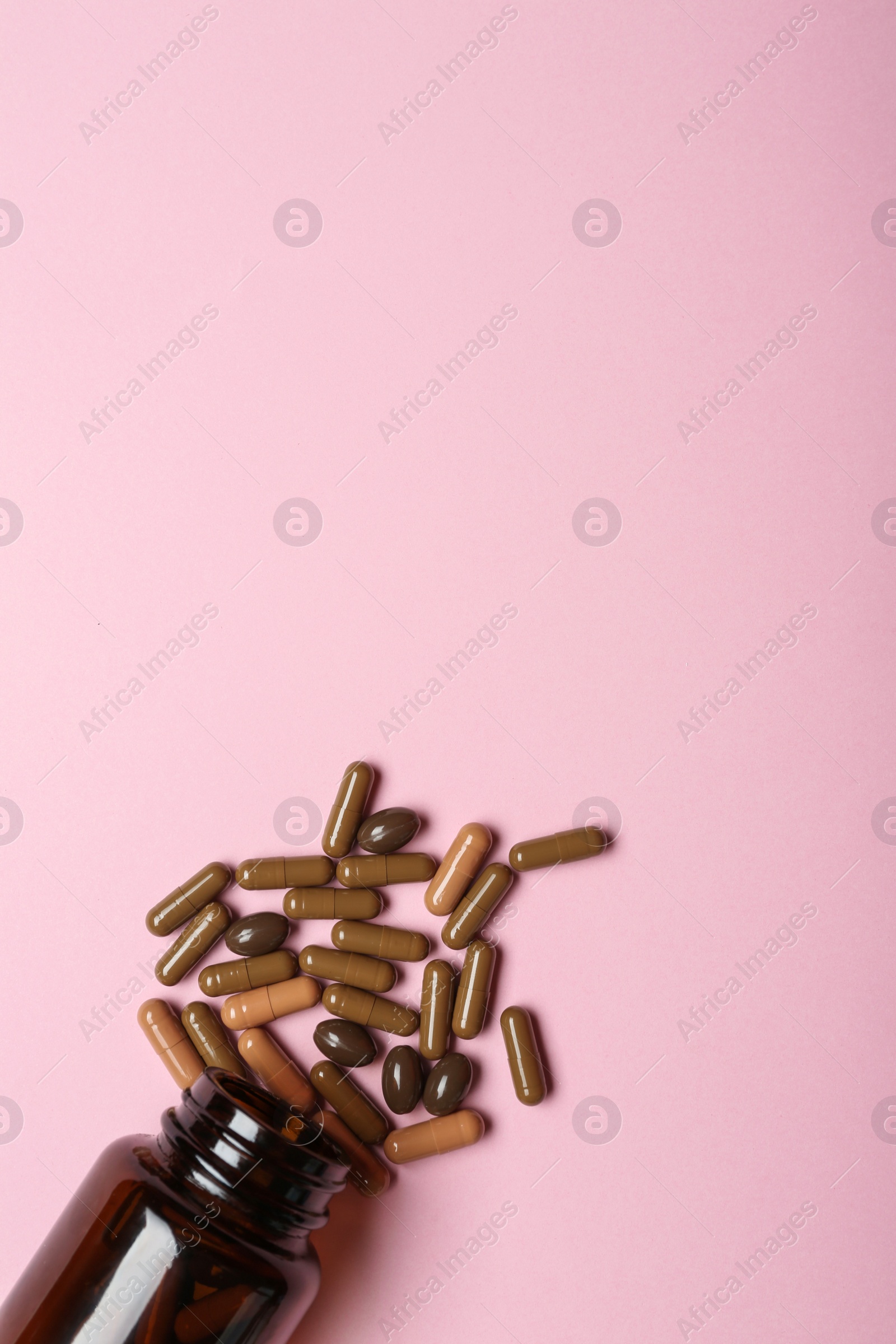 Photo of Bottle with vitamin capsules on color background, flat lay. Space for text