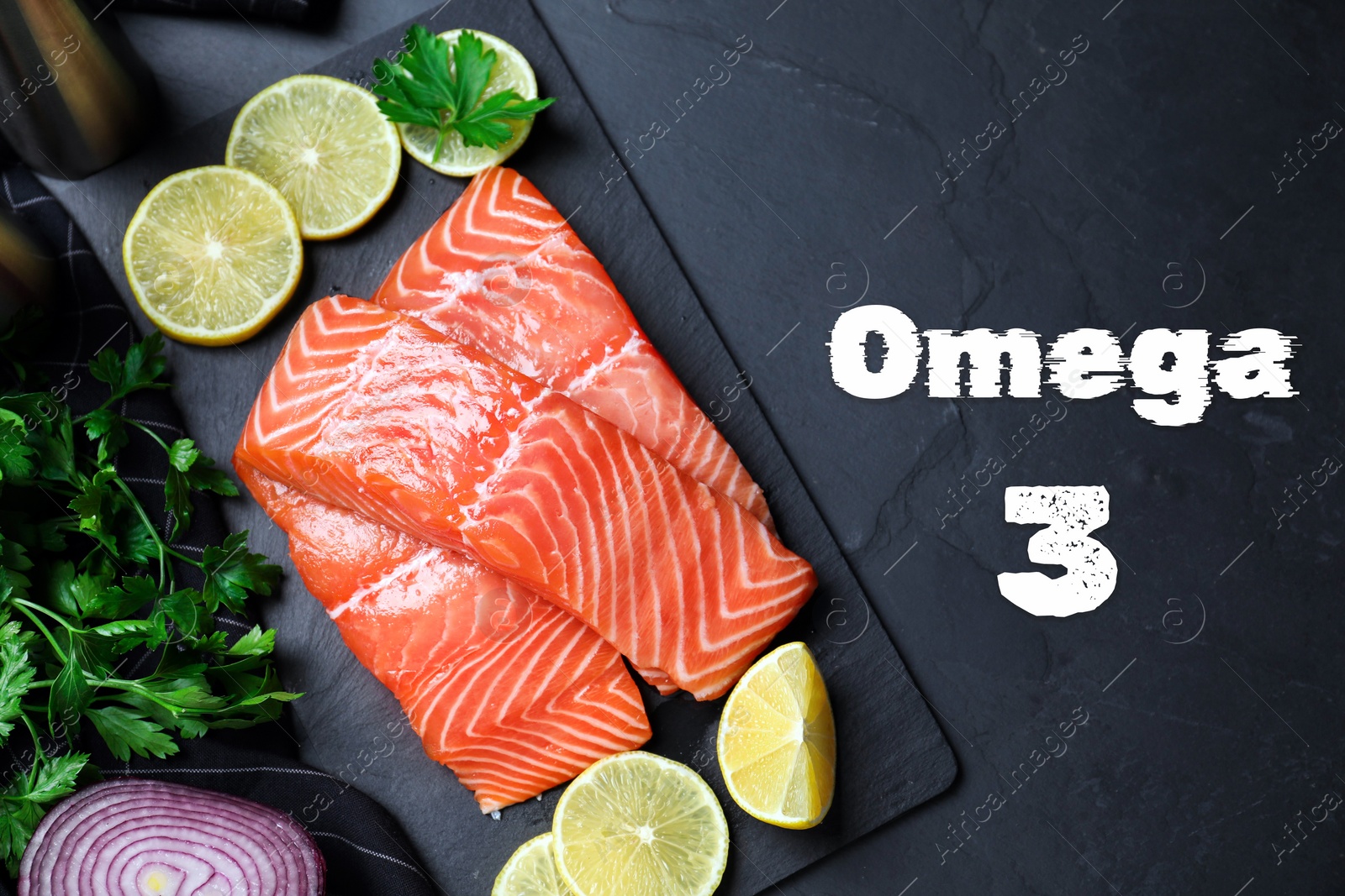 Image of Omega 3. Fresh cut salmon, parsley, lemon and onion on black table, flat lay