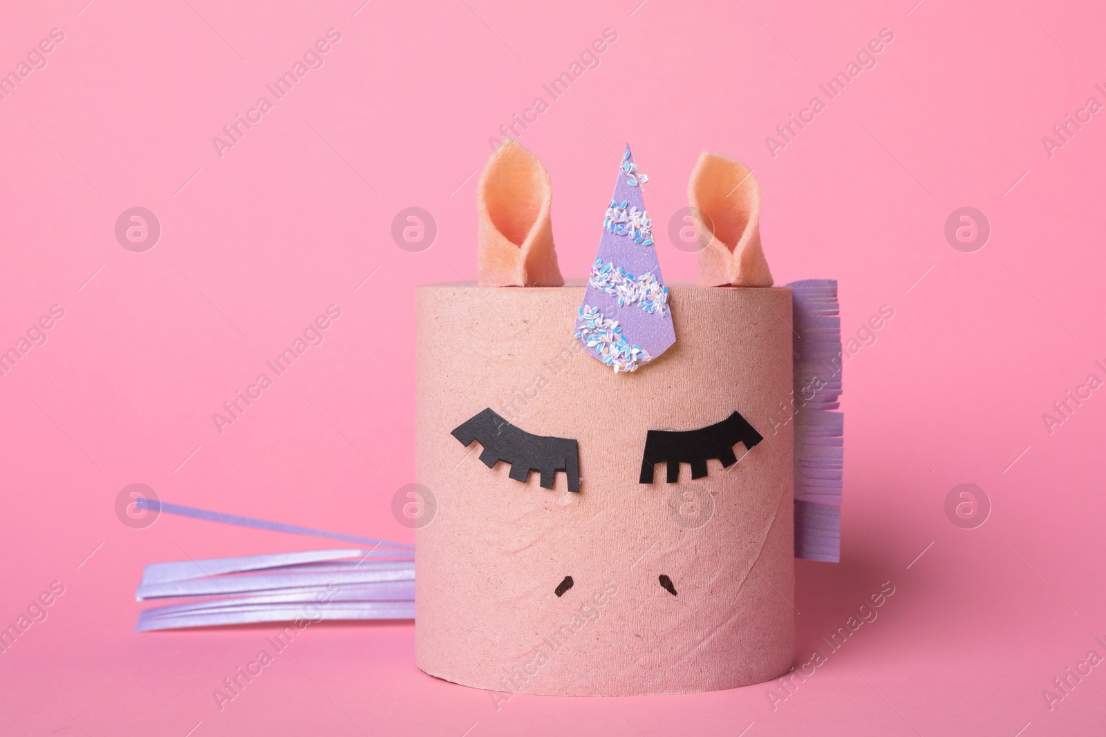 Photo of Toy unicorn made of toilet paper roll on pink background