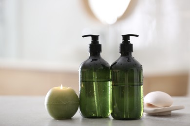 Photo of Green soap dispensers on white countertop in bathroom