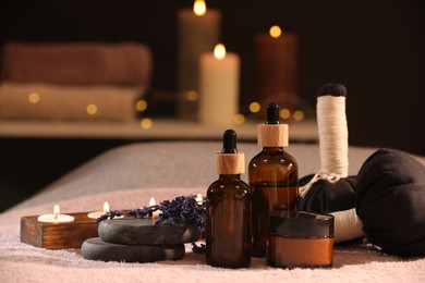 Photo of Composition with spa products and burning candles on soft light surface