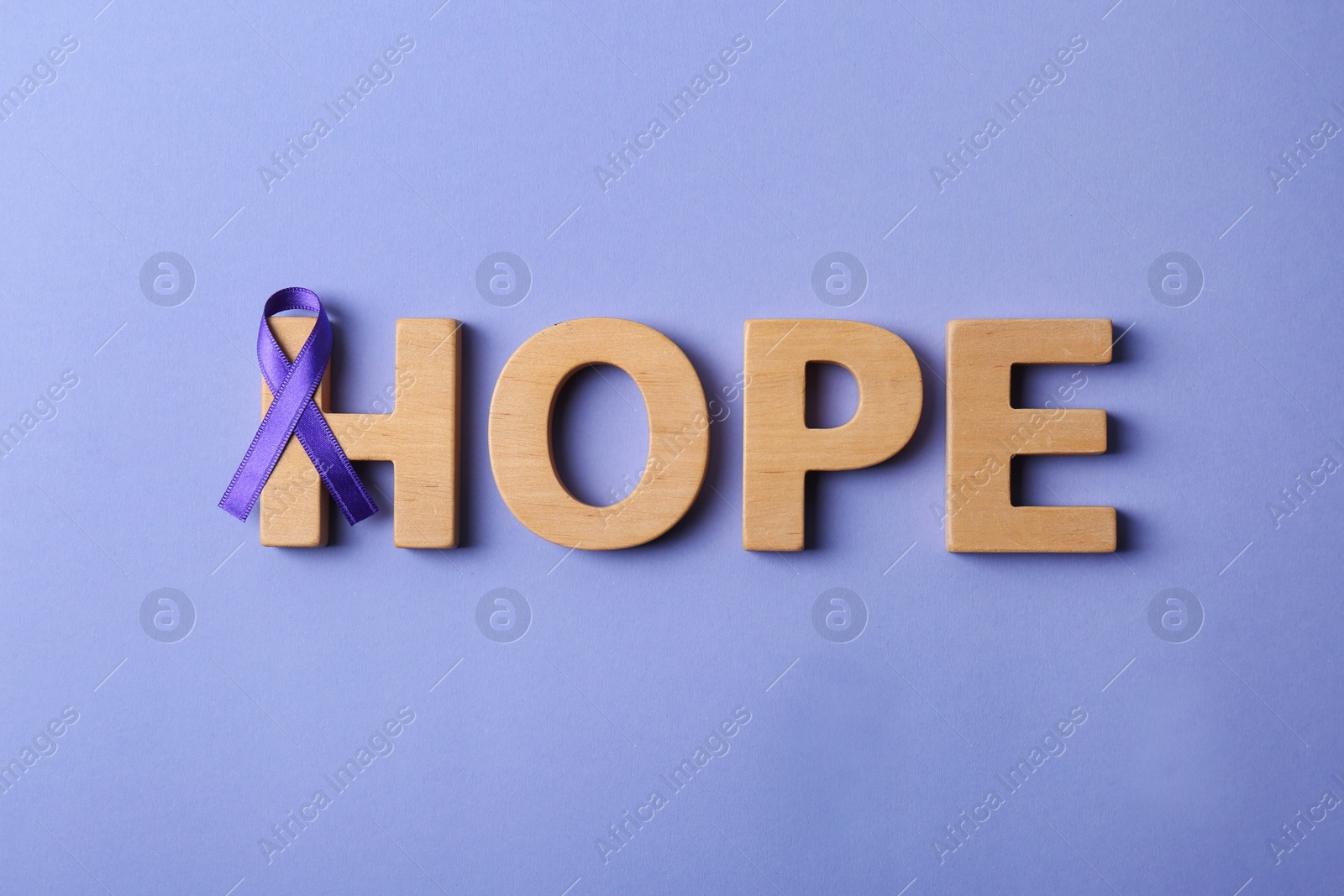 Photo of Flat lay composition with purple ribbon and word HOPE on violet background. Domestic violence awareness