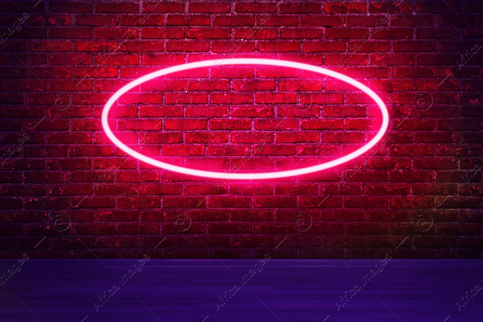 Image of Glowing neon sign on brick wall in room