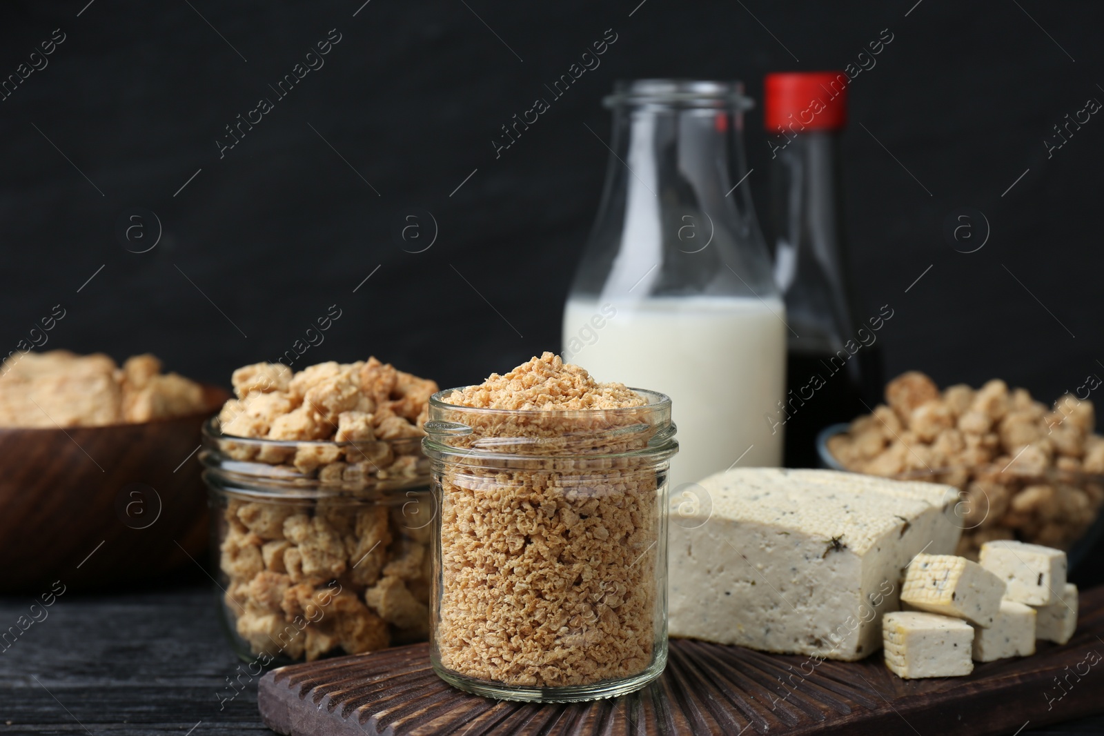 Photo of Different natural soy products on black table
