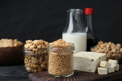 Photo of Different natural soy products on black table