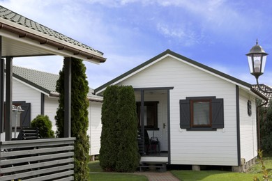 Photo of Beautiful modern white houses and plants outdoors