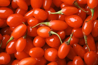 Fresh ripe goji berries as background, top view