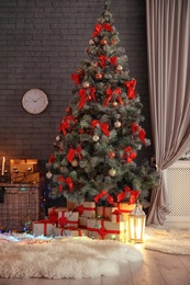 Photo of Stylish room interior with decorated Christmas tree