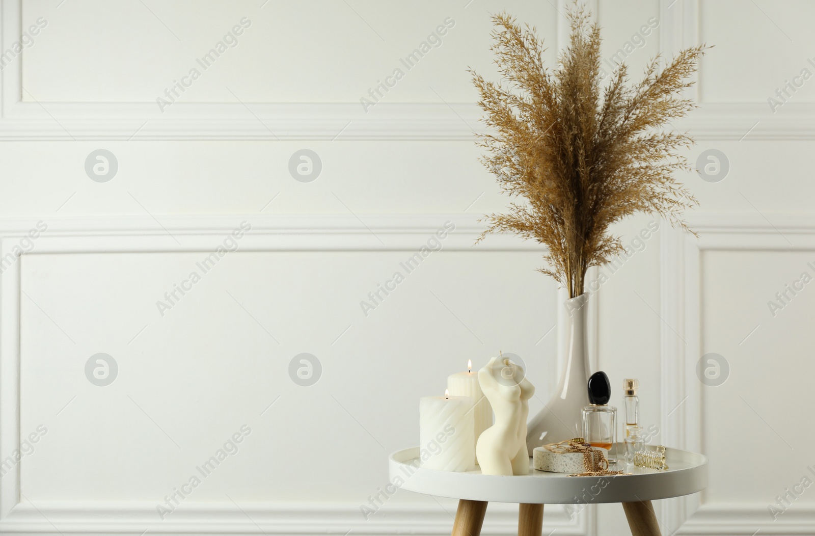 Photo of Female body shaped candle on white table, space for text. Stylish decor