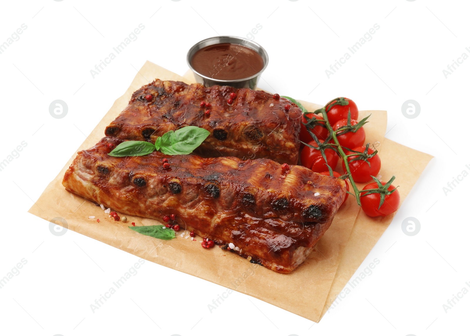 Photo of Tasty roasted pork ribs, sauce, basil and tomatoes isolated on white,