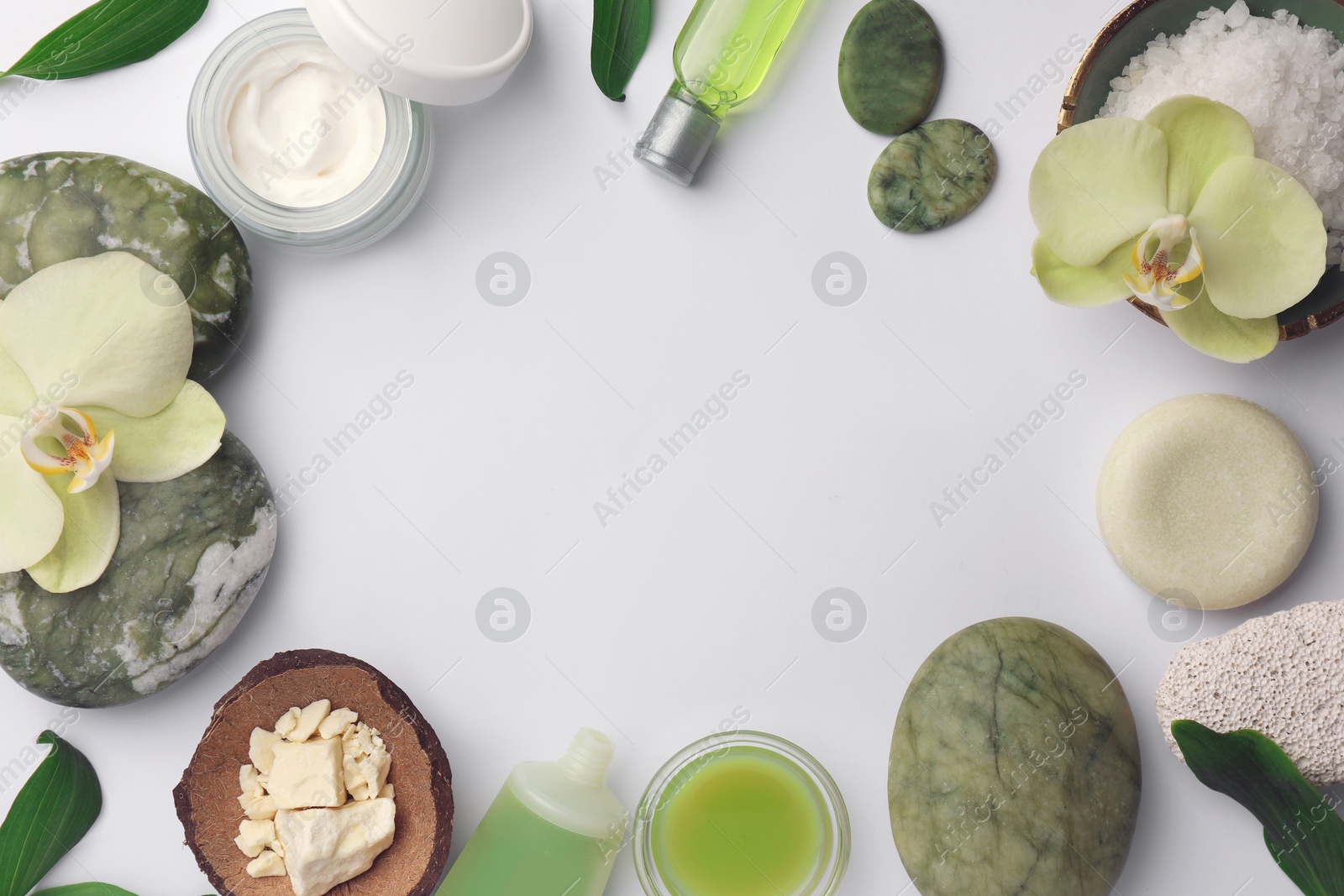 Photo of Frame made of different cosmetic products on white table, flat lay and space for text. Spa composition