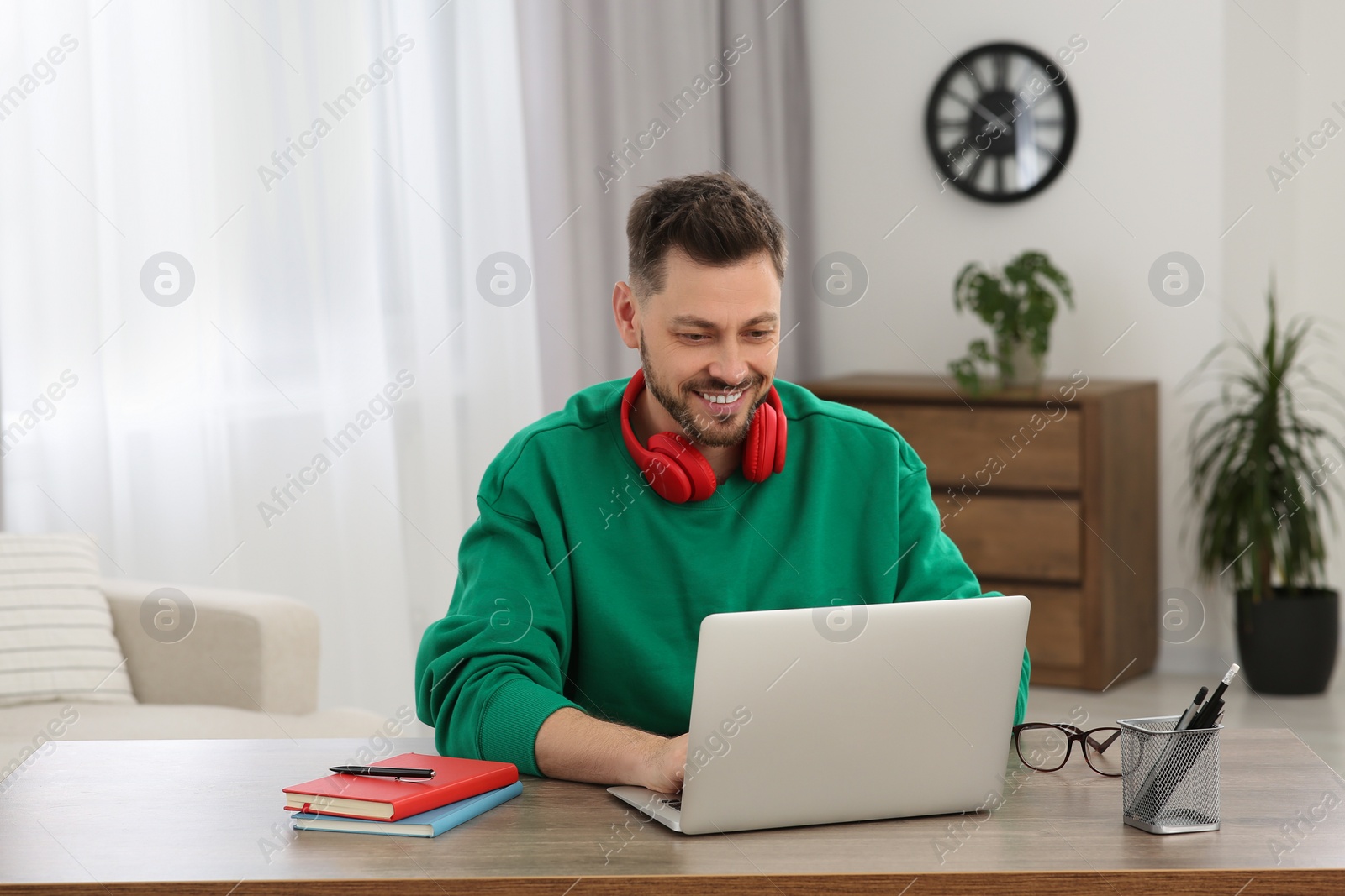 Photo of Man studying on laptop at home. Online translation course