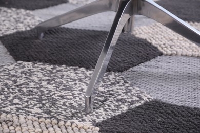 Photo of Modern office chair on carpet, closeup view