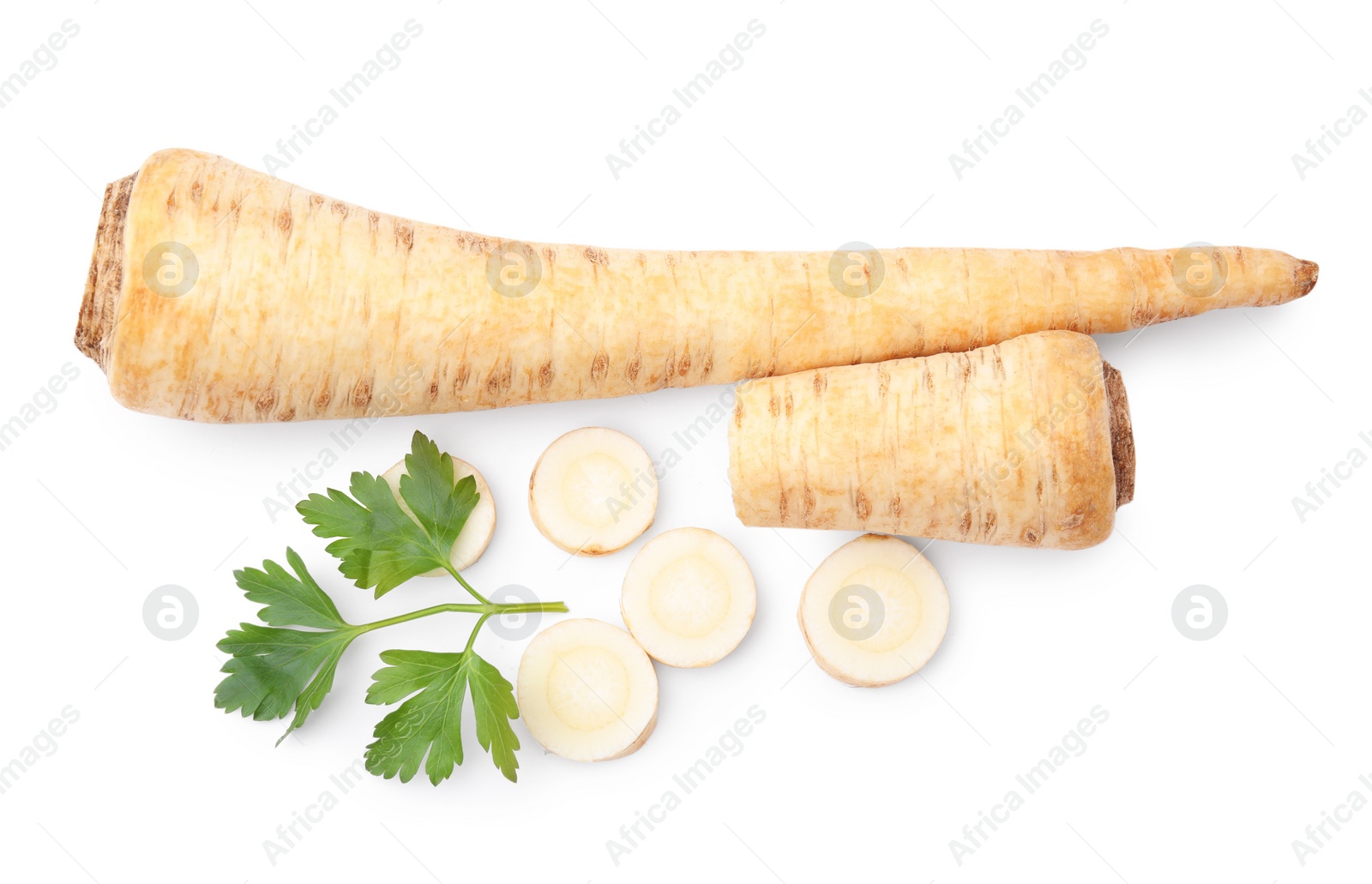 Photo of Whole and cut raw parsley roots, fresh herb isolated on white, top view