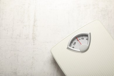 Photo of Weigh scales on white textured background, top view with space for text. Overweight concept