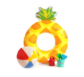 Photo of Bright inflatable ring and ball with beach toys on white background