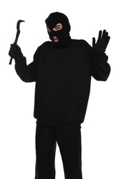 Emotional thief in balaclava with crowbar raising hands on white background