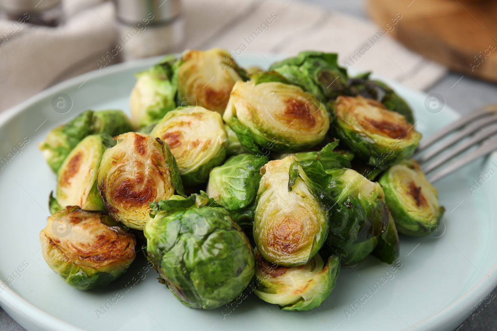 Photo of Delicious roasted Brussels sprouts on table, closeup
