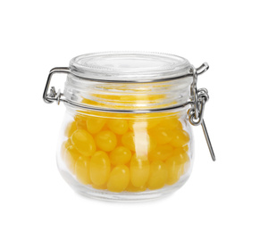 Photo of Tasty small lemon drops in glass jar isolated on white