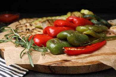 Delicious grilled vegetables on wooden board, closeup
