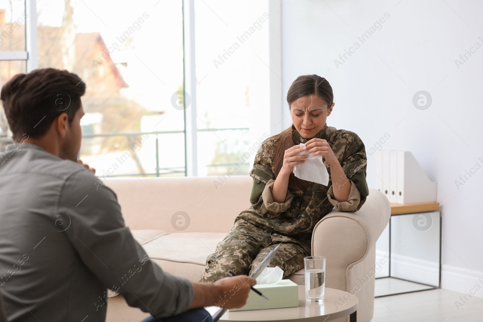 Photo of Psychotherapist working with female military officer in office