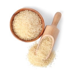 Bowl and scoop with uncooked parboiled rice on white background, top view